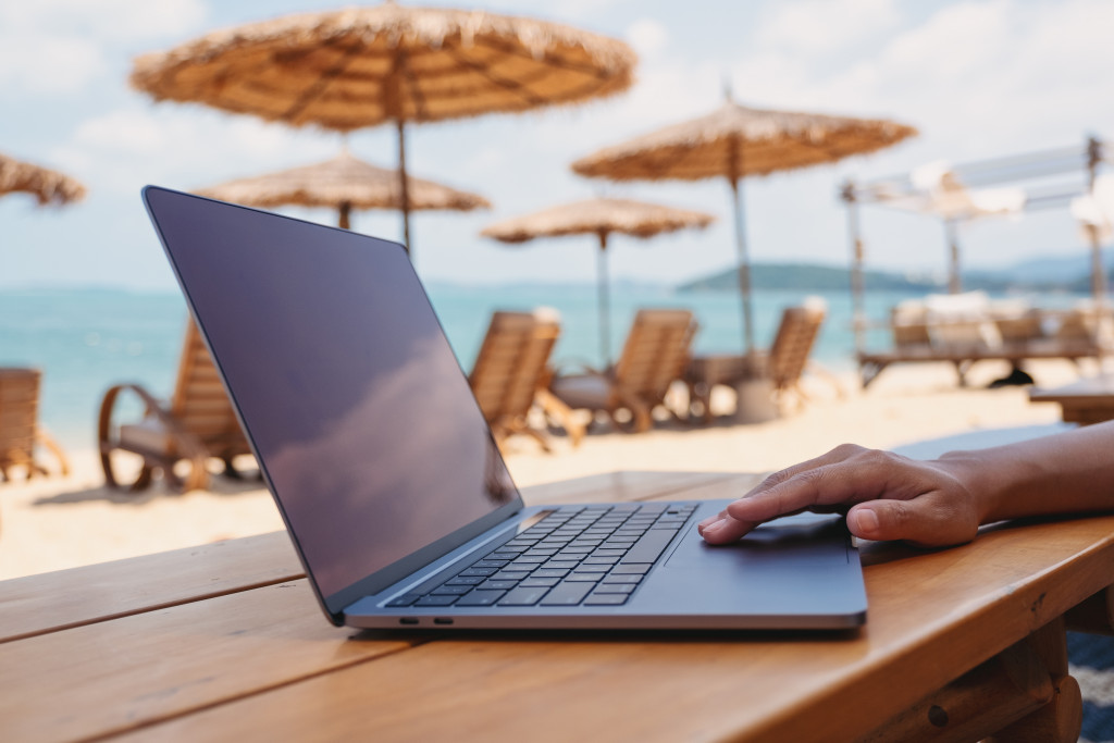 a person using laptop at the beach
