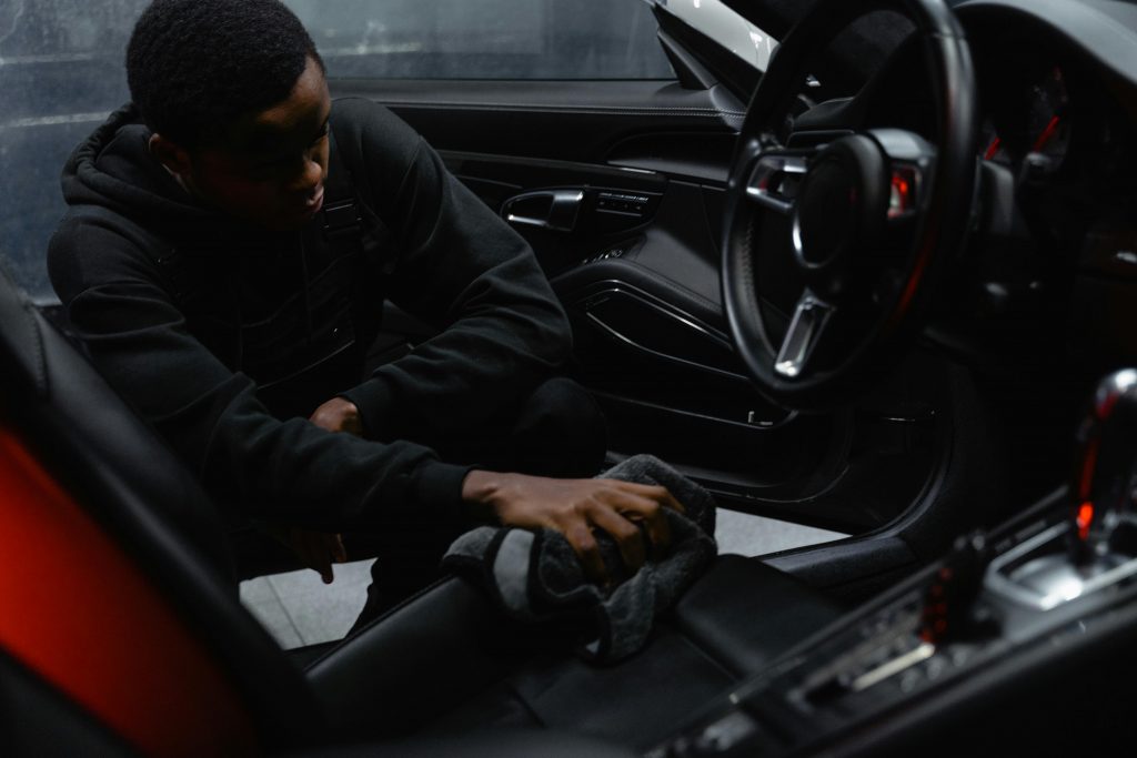 a man cleaning a car seat