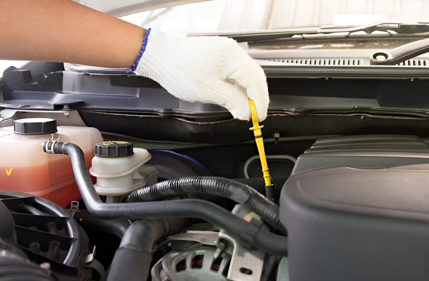 close-up of a man checking a car's transmission fluid level