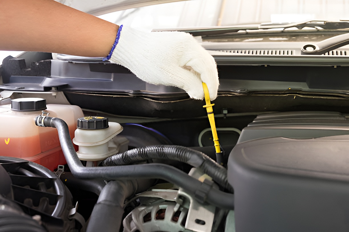 close-up of a man checking a car's transmission fluid level